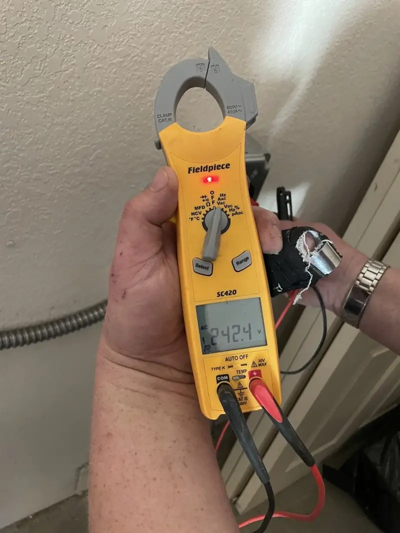 Voltage testing with clamp meter during Outlet Installation in Spout Springs